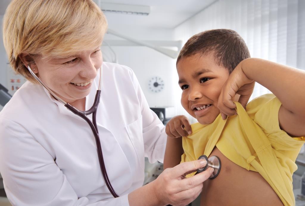 Photo of physician checking child with stethoscope