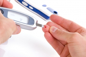 Image of individual using a blood glucose meter